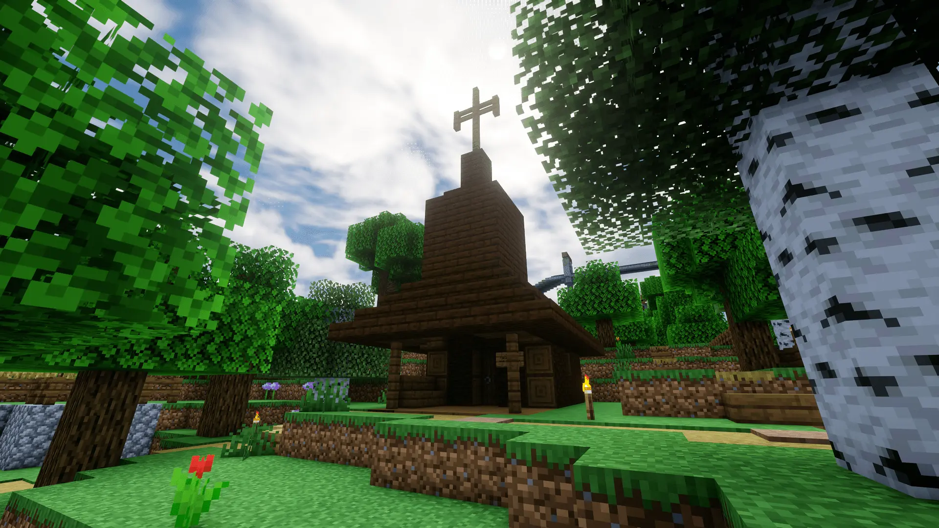 The compact wooden chapel stands among the trees