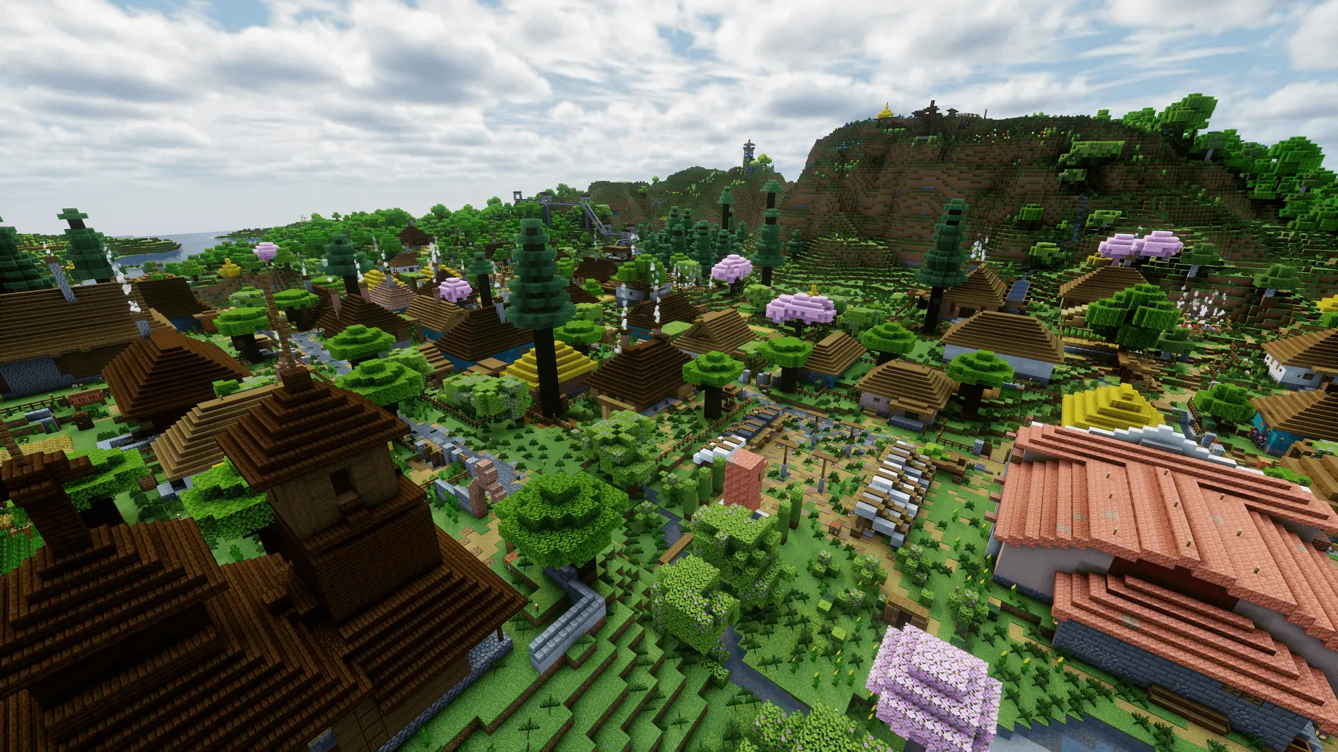 A wide, almost aerial view of the market and local church, many houses, and mountains in the background
